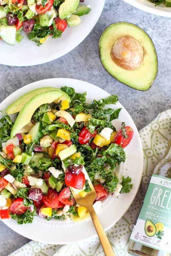 Primal Kitchen Greek Vinaigrette with Kale Salad on a white plate