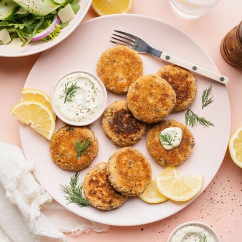 A plate of tuna patties with a bowl of garlic aioli.