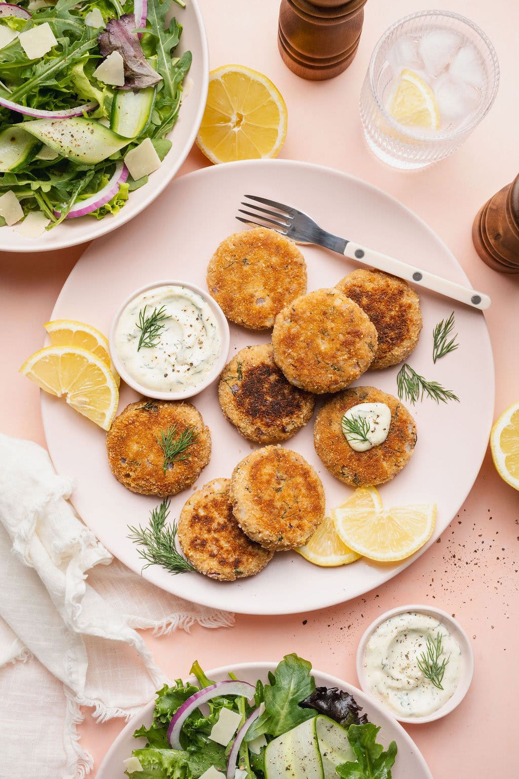 A plate of tuna patties with a small bowl of lemon aioli.