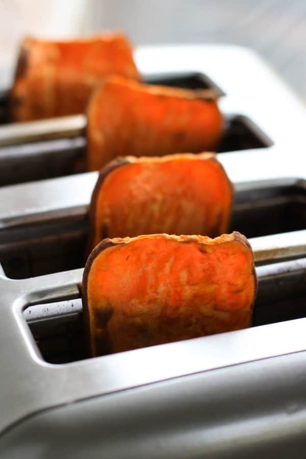 Four thinly sliced sweet potato 'planks' in a toaster