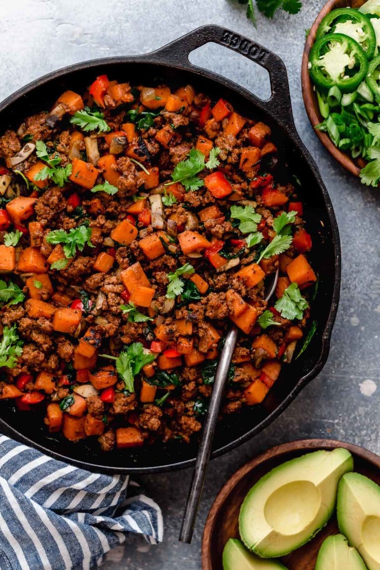 Tex-Mex Sweet Potato Hash in a cast iron skillet topped with fresh cilantro. 