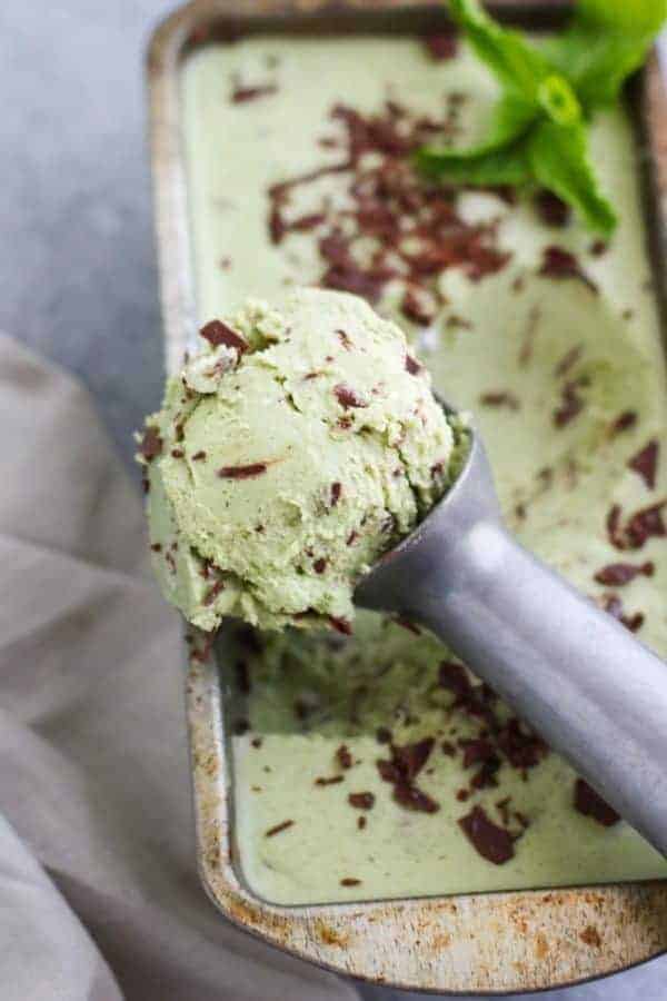 Dairy-free Mint Chocolate Chip Ice Cream on a silver ice cream scooper being scooped towards the camera