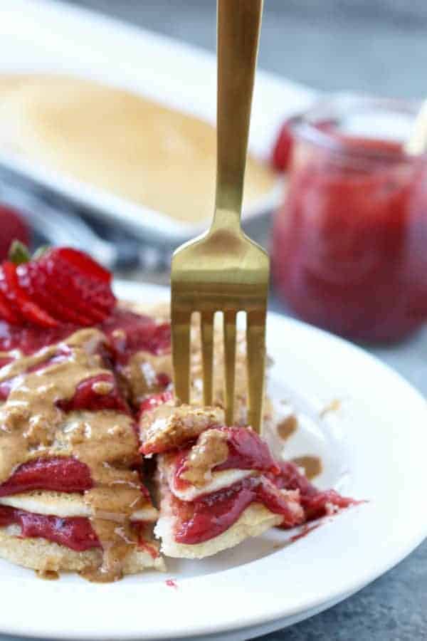 Paleo Vegan Pancakes close up with a piece on a golden fork