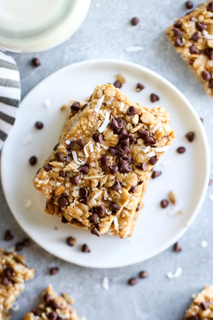 An overhead view of chocolate chip Clif bars stacked on each other on a white plate