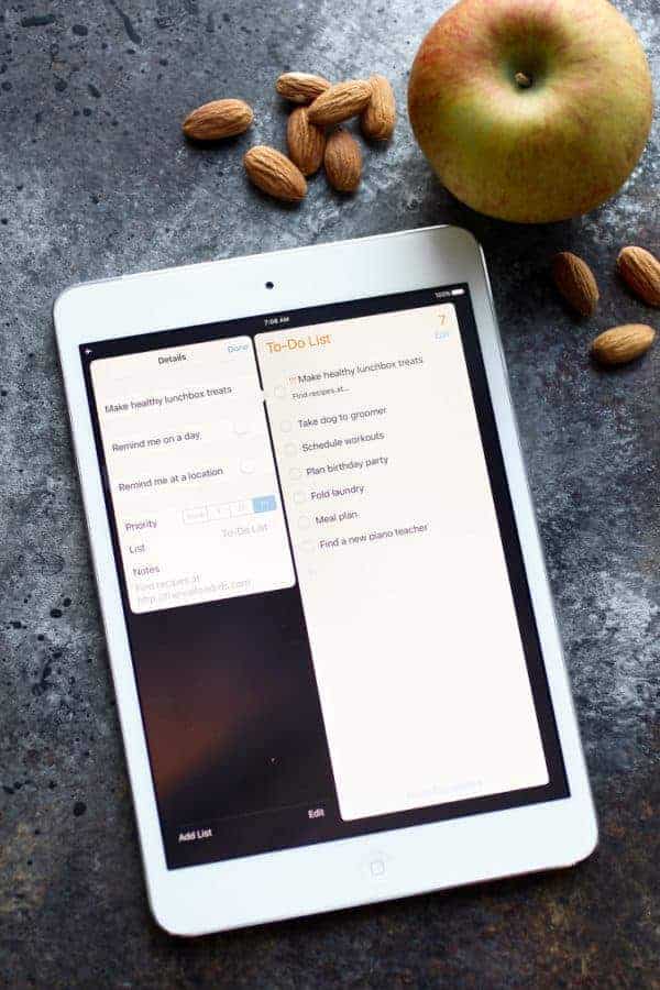 IPad with to-do list loaded and an apple and some nuts on the side