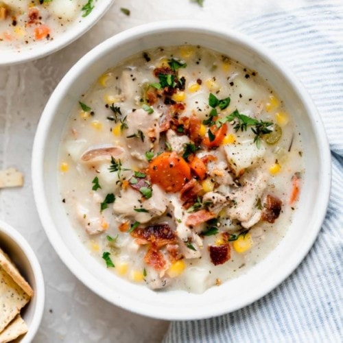 Overhead view white bowl filled with creamy chicken corn chowder