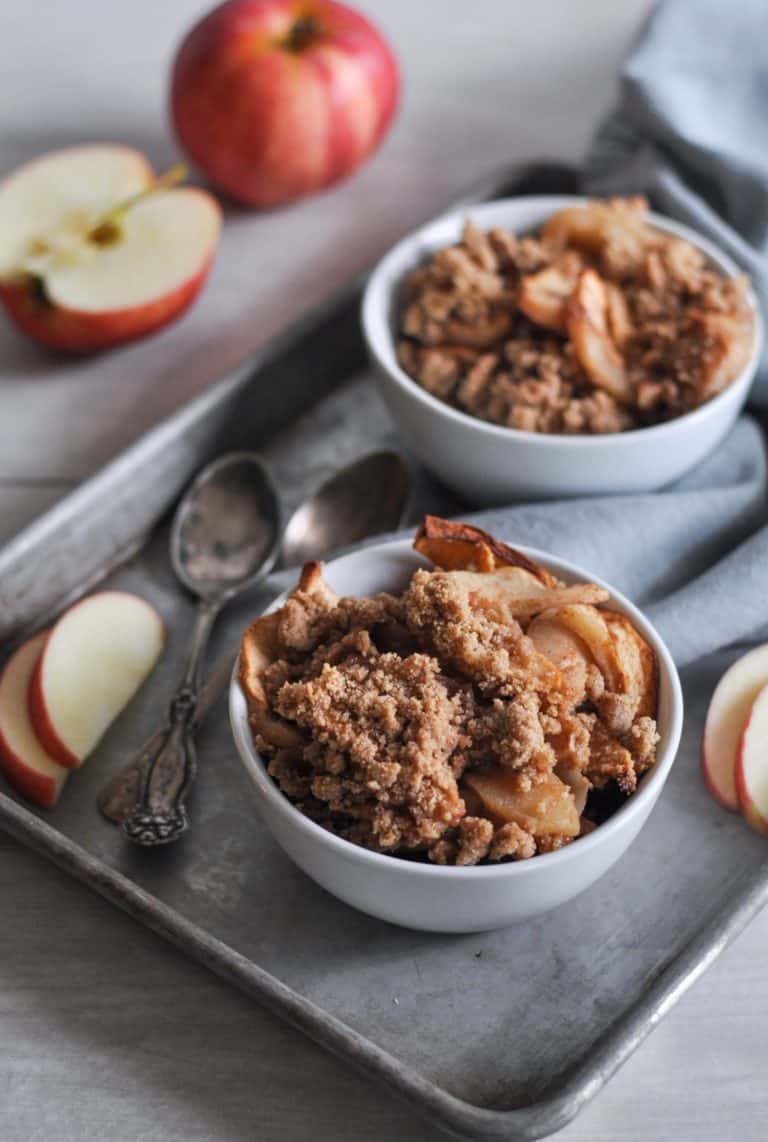 A tray of Gluten-free Harvest Apple Crisp in bowls. 