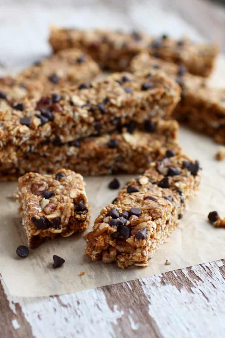 A stack of No-bake Pumpkin Chocolate Chip Granola Bars flavored with pumpkin pie spice and studded with chocolate chips. 