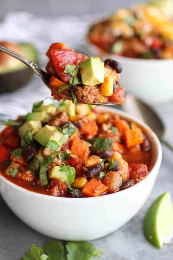A spoonful of Veggie Loaded Turkey Chili lifted towards the camera
