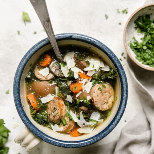 Overhead view bowl with handle filled with Harvest Italian Soup with Sausage.