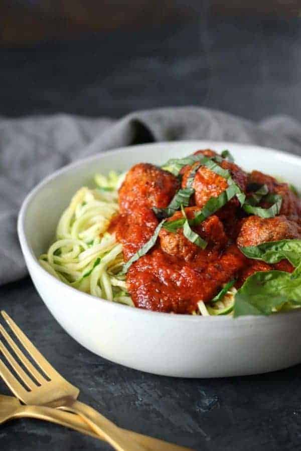 meatballs and marinara on zucchini noodles in a bowl