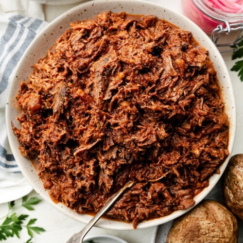 Overhead view stone serving bowl filled with shredded BBQ beef