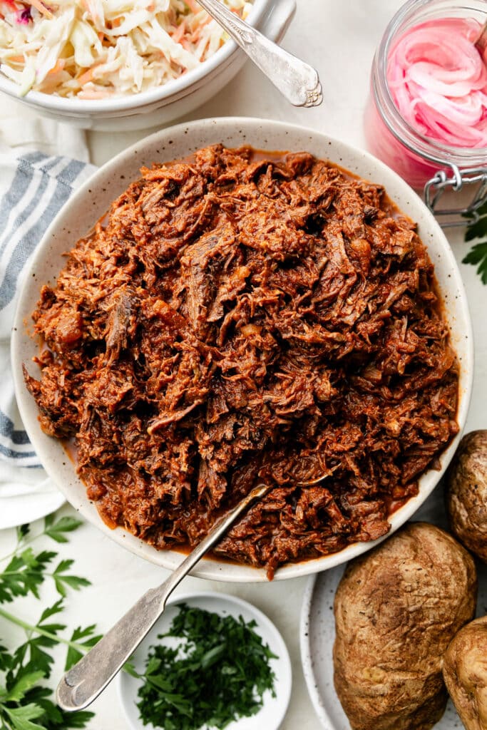 Overhead view stone serving bowl filled with shredded bbq beef