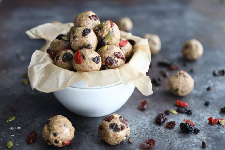 Trail mix energy bites in parchment lined white bowls
