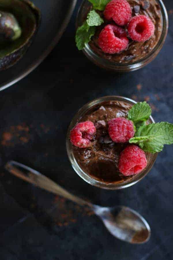 Overhead view of chocolate mousse with a spoonful taken out. 