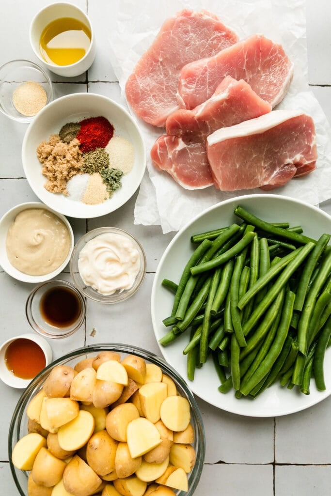 All ingredients for sheet pan honey mustard pork chops arranged together.