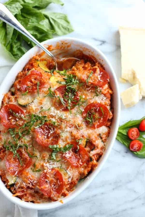 pepperoni pizza quinoa bake with a serving spoon