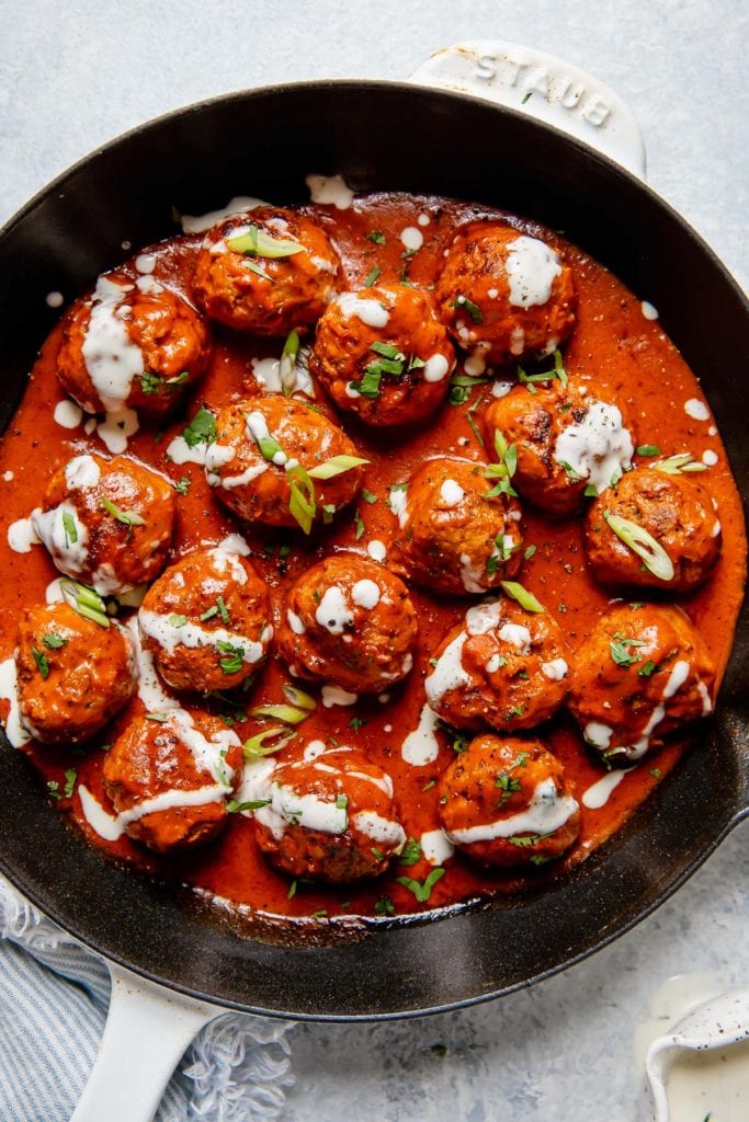 Whole30 Appetizers roundup includes Buffalo Chicken Meatballs shown in a black skillet with ranch drizzled over top.