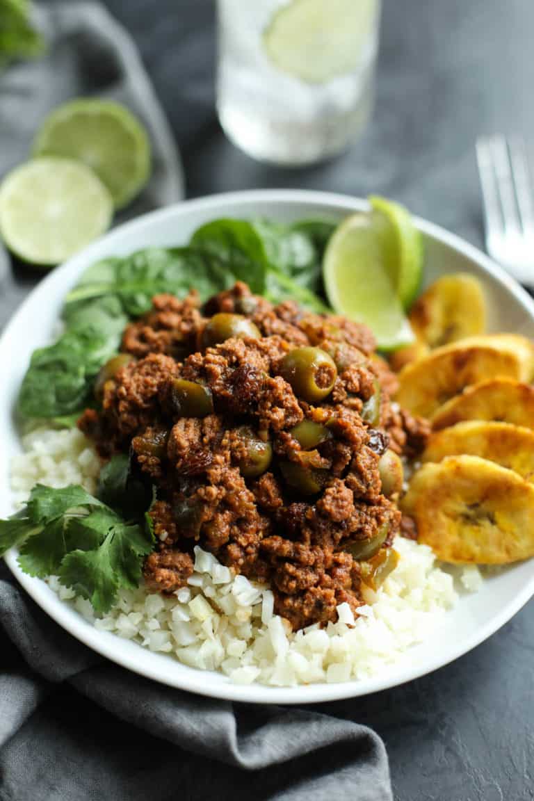 slow cooker picadillo on a bed of rice with plantains