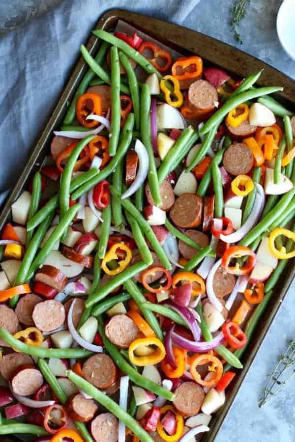 One-Pan Kielbasa Veggie Bake ingredients on a sheet pan