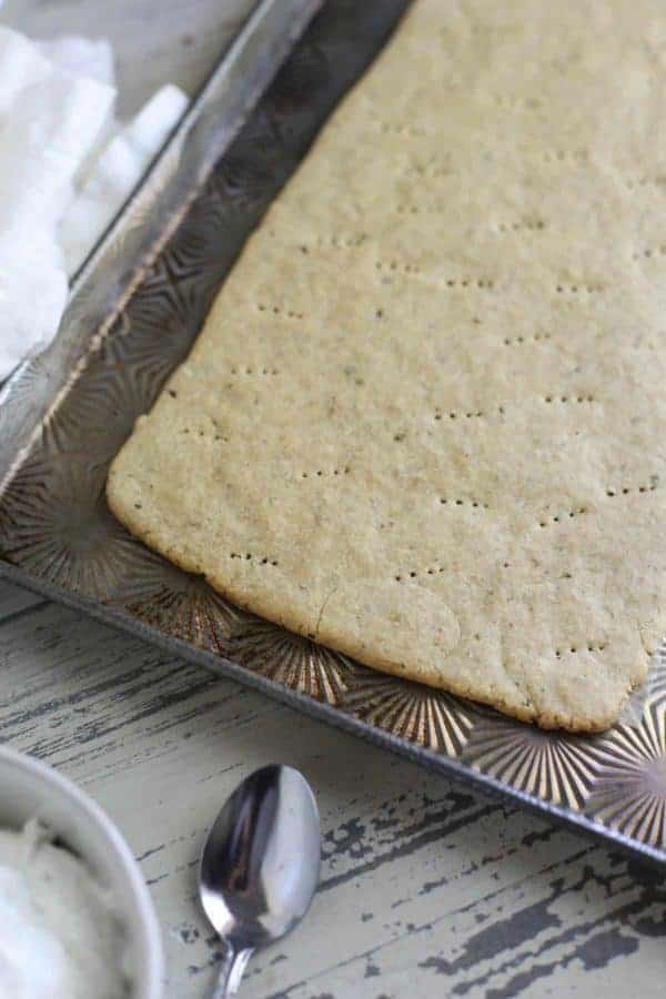 plain pizza crust on a cookie sheet