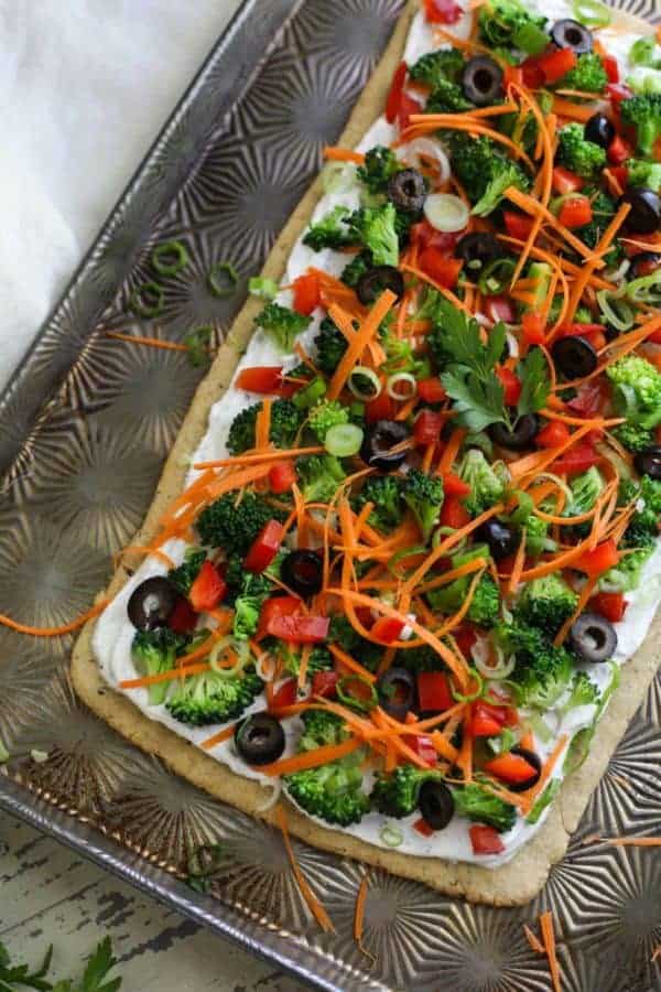 uncooked Gluten-free Veggie Pizza on a baking sheet