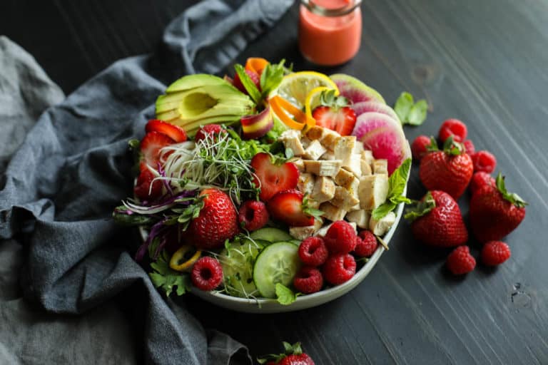 Large bowl of berry protein salad with fresh fruits and vegetables. 