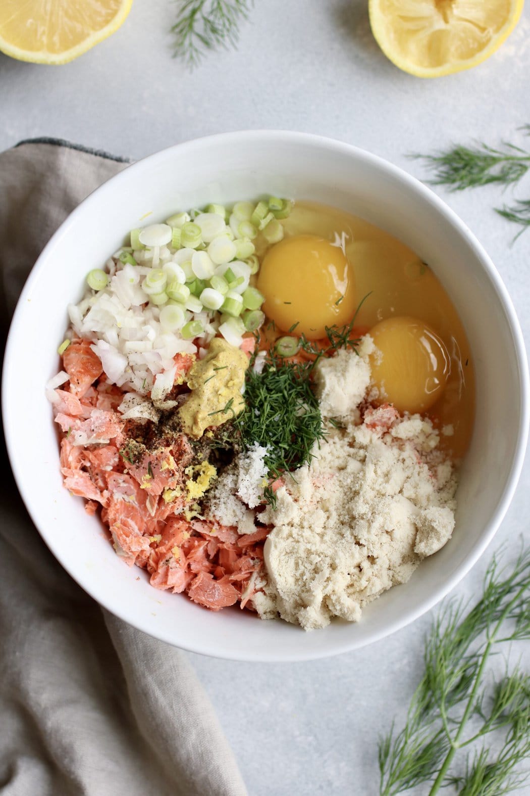 Overhead view white bowl with all ingredients for salmon burgers