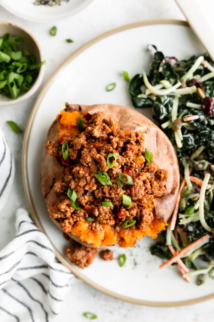 Overhead view baked sweet potato stuffed with healthy sloppy joe mixture.