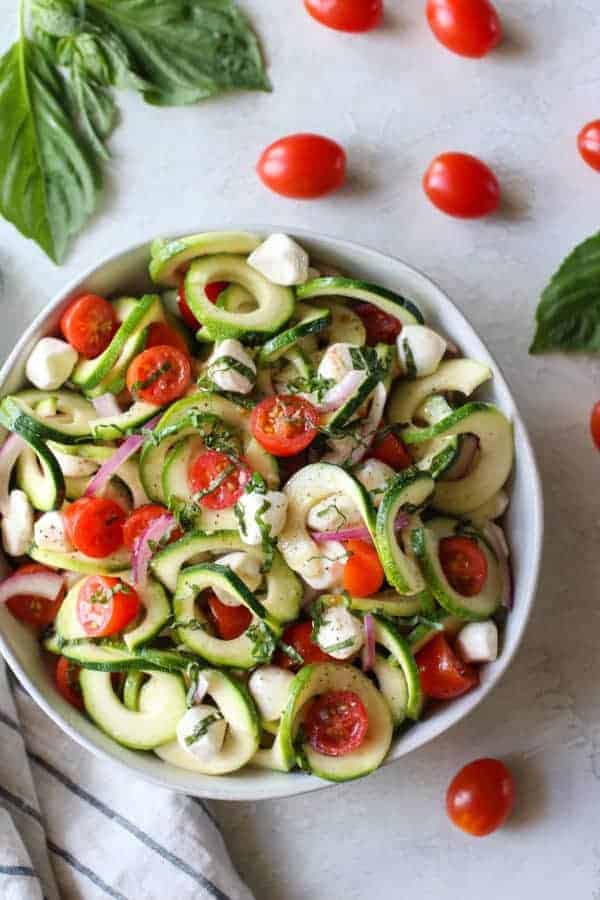 Caprese Zucchini Salad with Balsamic Vinaigrette in a white bowl