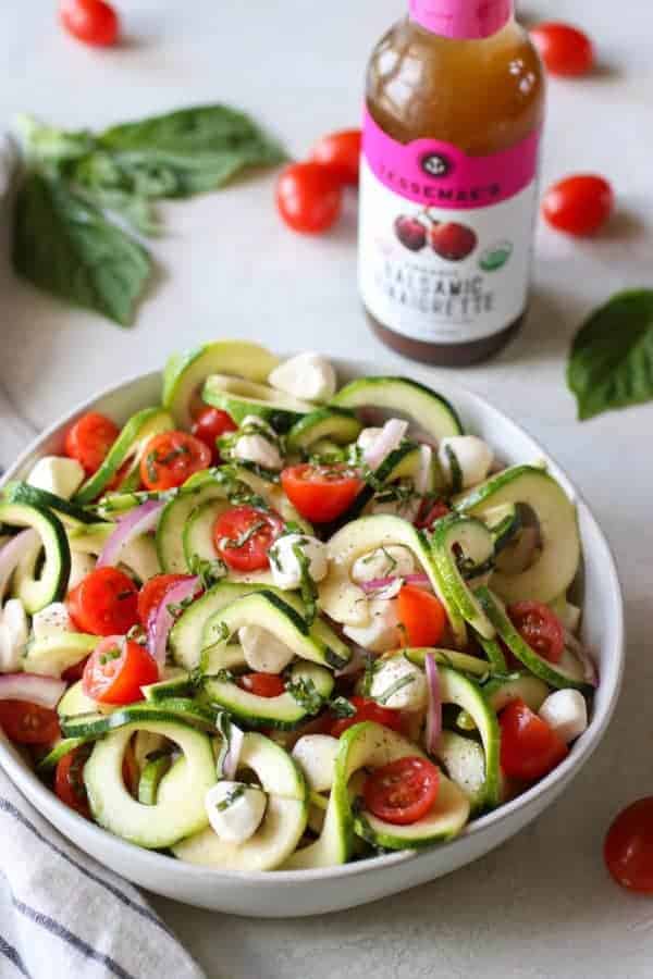 Caprese Zucchini Salad with Balsamic Vinaigrette in a white bowl