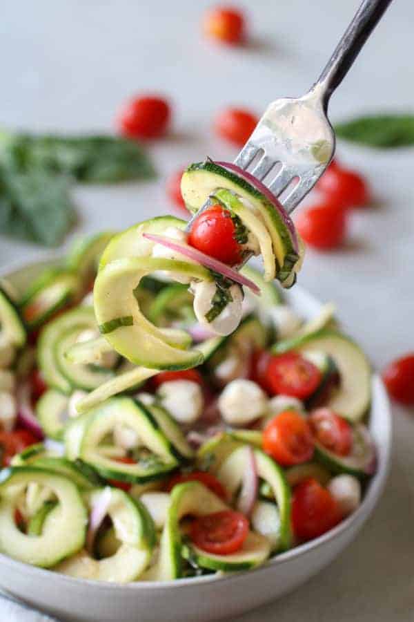 Caprese Zucchini Salad with Balsamic Vinaigrette on a fork