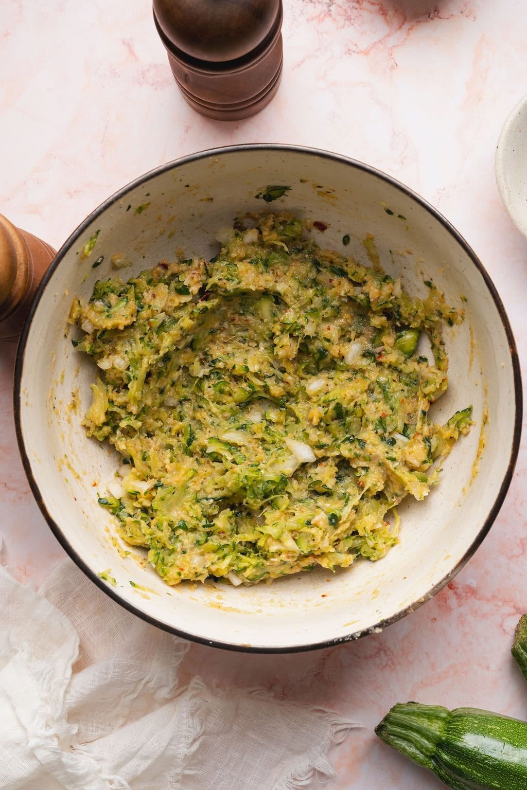 Zucchini fritter batter in a bowl.