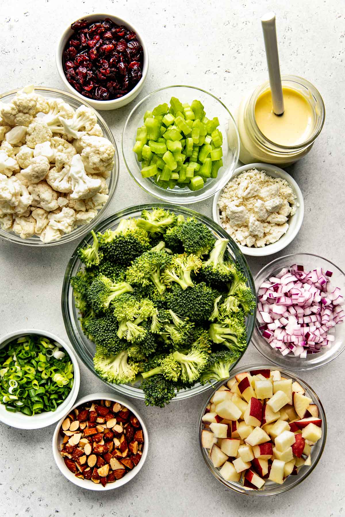 Ingredients to make apple broccoli cauliflower salad.