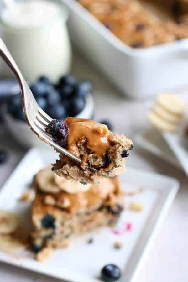 Blueberry Banana Walnut Muffin Bars on a fork lifted towards the camera