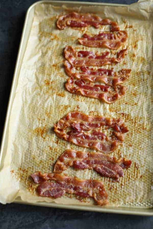 aerial view of bacon strips cooling on a cookie sheet