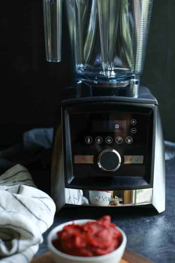 Vitamix Ascent A3500 blender with a small bowl of tomato paste in the foreground. 