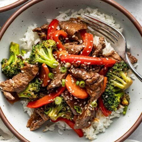Overhead view of a plate filled with Steak Stir Fry over white rice.
