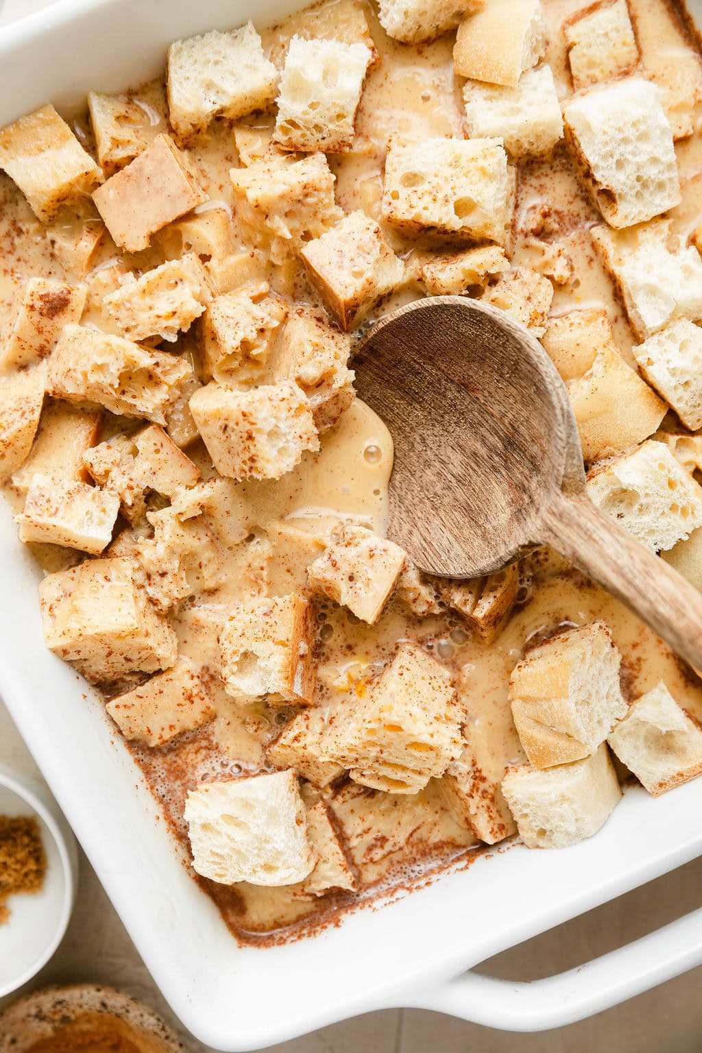 Overhead view of French toast casserole ingredients in a baking dish ready for baking. 