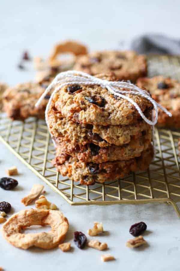 Four Apple Cinnamon Breakfast Oat Cookies stacked on a wire rack and tied with a string