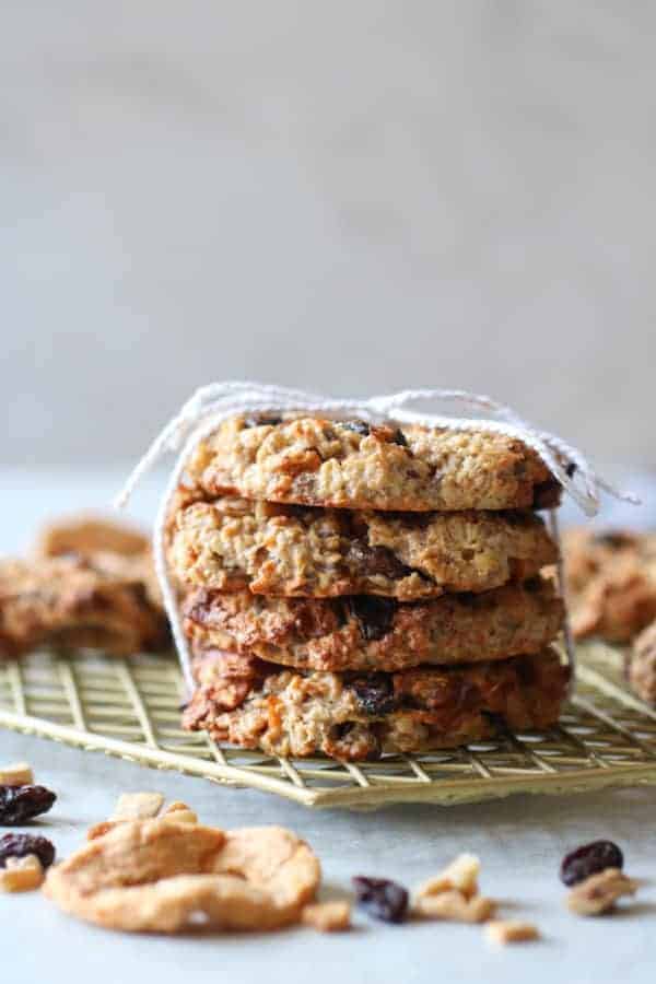 Four Apple Cinnamon Breakfast Oat Cookies stacked and tied together with a string on a wire cooling rack 