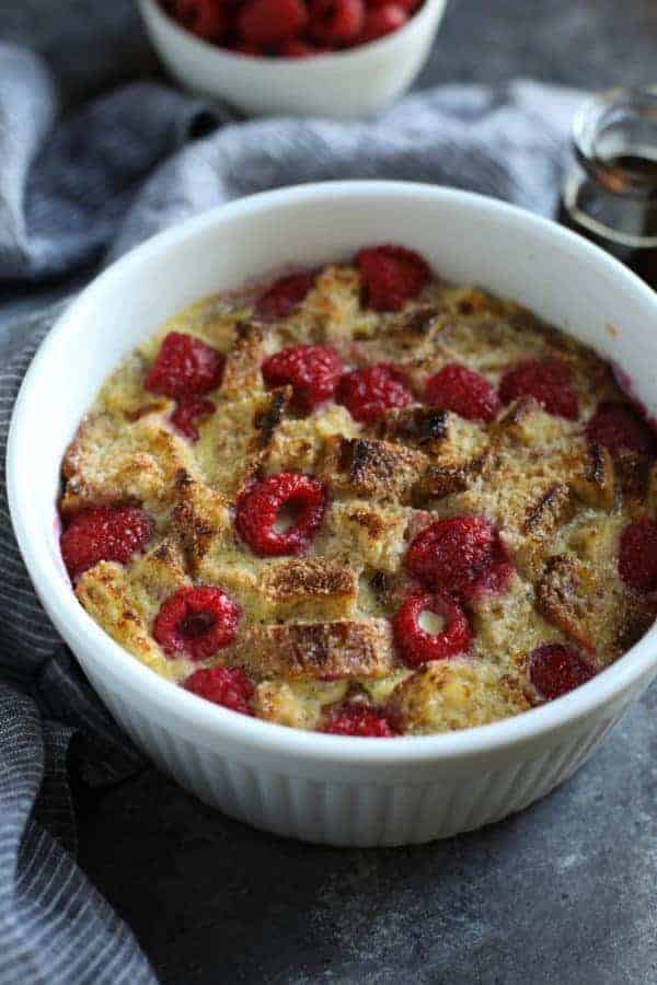 White souffle dish filled with Instant Pot Raspberry French Toast Casserole. 