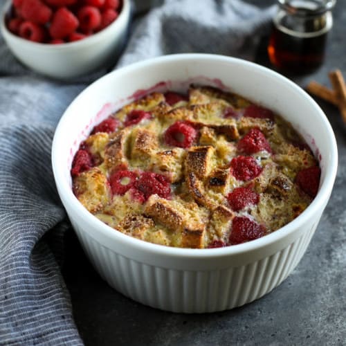 White souffle dish with Instant Pot Raspberry French Toast Casserole.