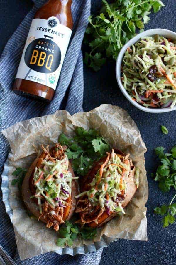 aerial view of Instant Pot BBQ Pulled Chicken in a sweet potato with Tessemae's Organic BBQ Sauce