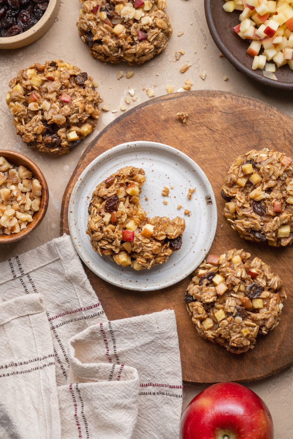 Apple oatmeal cookies, one on a plate missing a bite.
