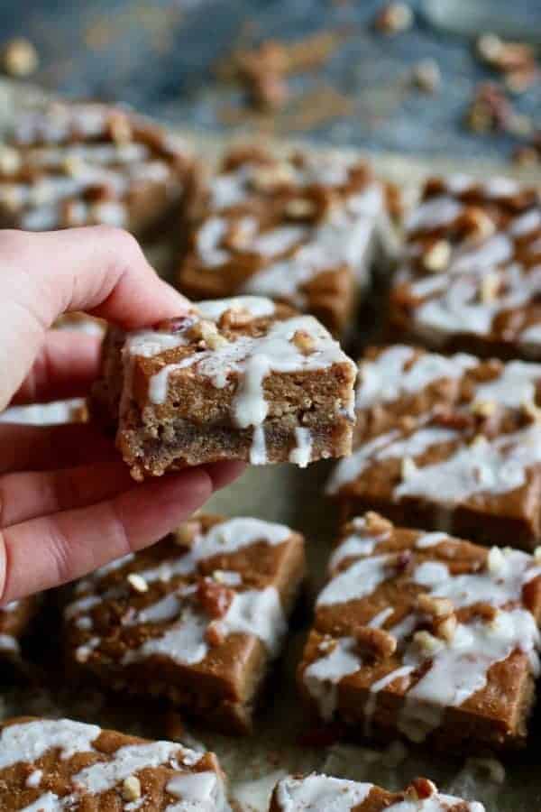 Close up view of one Paleo Pumpkin Pie Bar lifted towards the camera