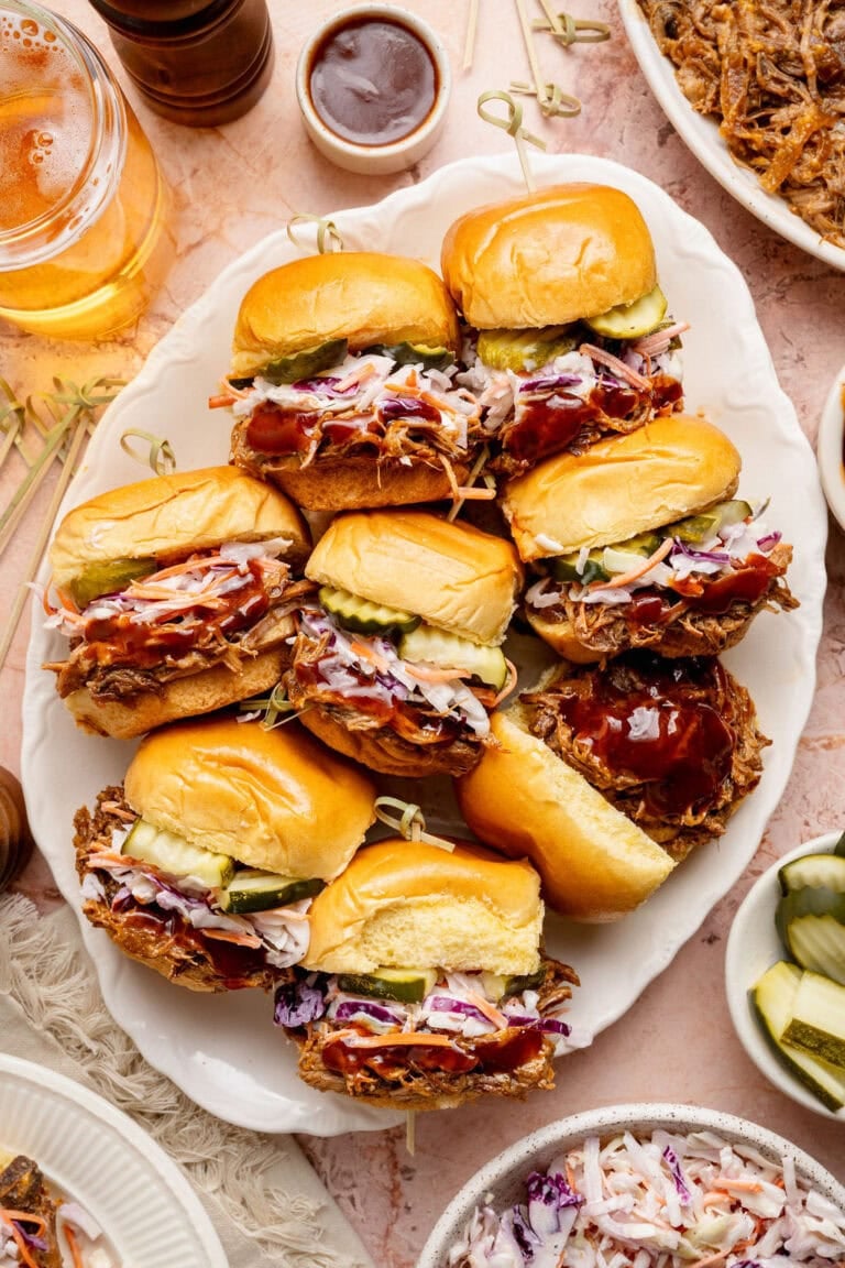 Overhead view of a platter of Pulled Pork Sliders topped with coleslaw