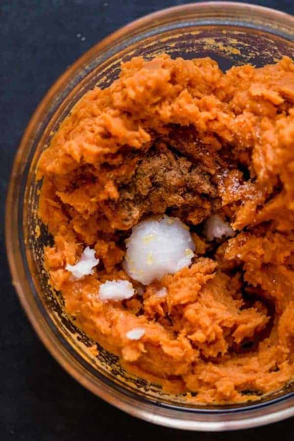 Overhead view mashed maple sweet potatoes in clear glass bowl