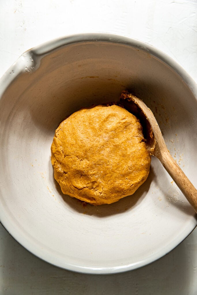 Overhead view of a bowl filled with Gluten-Free Pumpkin Spice Scones dough. 