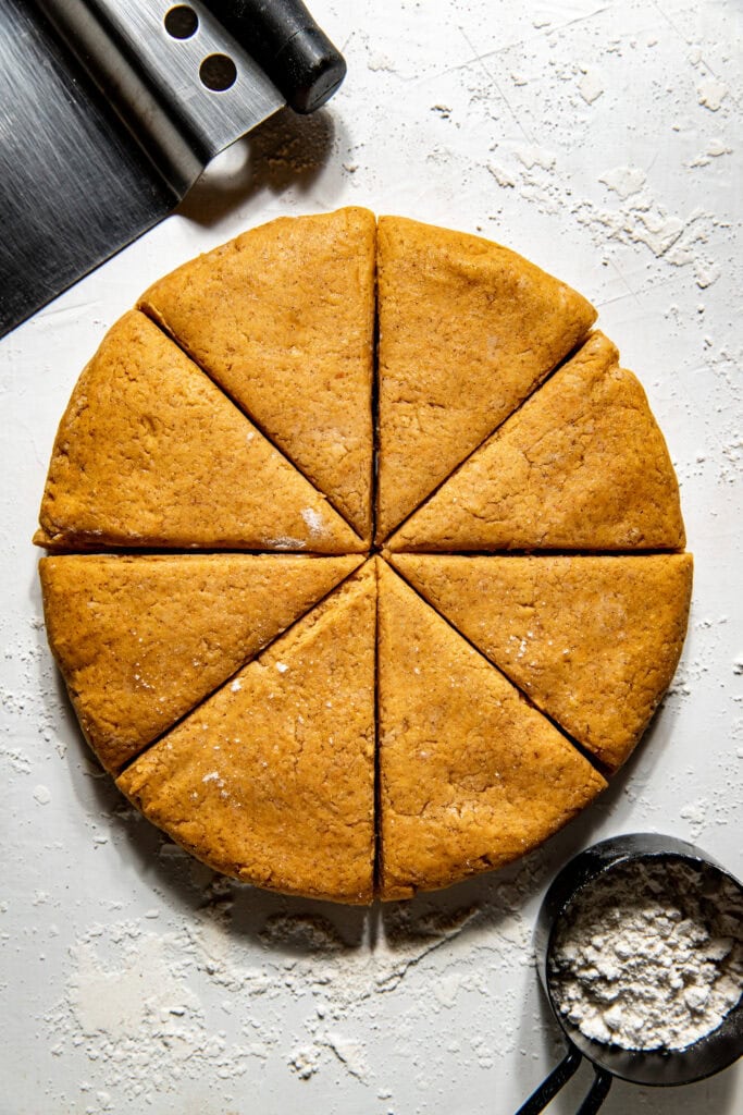 Freshly cut Gluten-Free Pumpkin Spice Scones dough ready for baking. 